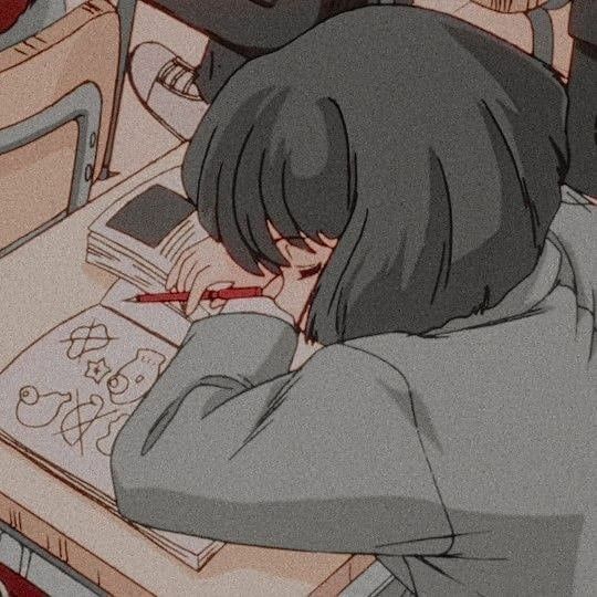 girl that has fallen asleep on a book at a desk